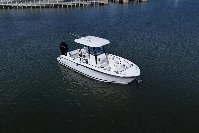 Slide: The Image of 2025 Blackfin 252 CC boat on calm water, showcasing sleek design and modern features. - 11