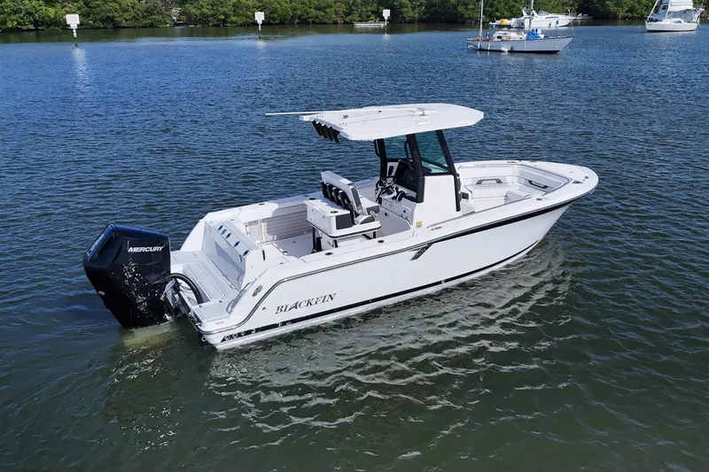 Slide: The Image of 2025 Blackfin 252 CC boat on calm water with Mercury engine. - 12