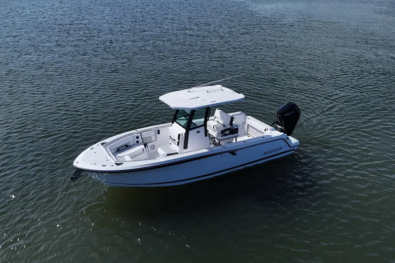 Slide: The Image of 2025 Blackfin 252 CC boat on calm water, showcasing sleek design and modern features. - 13
