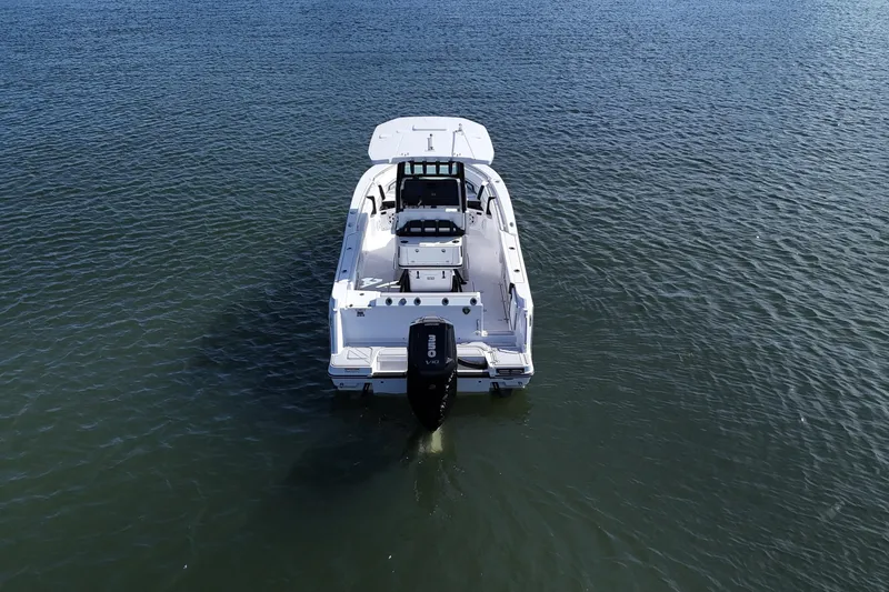 Slide: The Image of 2025 Blackfin 252 CC boat on calm water, rear view. - 14