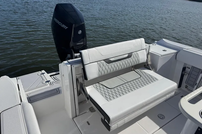Slide: The Image of 2025 Blackfin 252 CC boat with Mercury Verado engine and cushioned seating. - 17