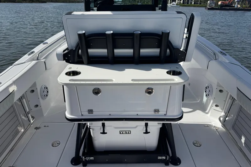 Slide: The Image of 2025 Blackfin 252 CC boat interior with fishing rod holders and Yeti cooler. - 18