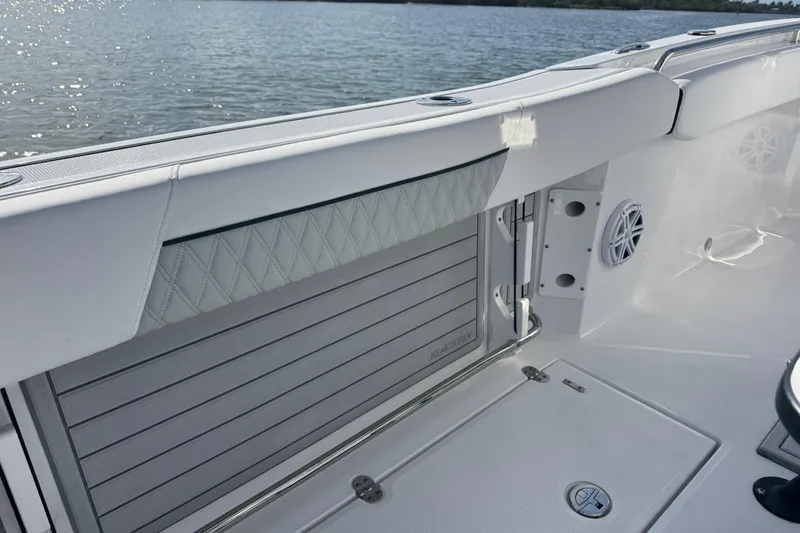 Slide: The Image of 2025 Blackfin 252 CC boat interior with sleek white seating and modern design. - 20