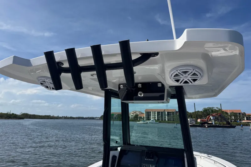 Slide: The Image of 2025 Blackfin 252 CC boat with speakers and rod holders on the water. - 22