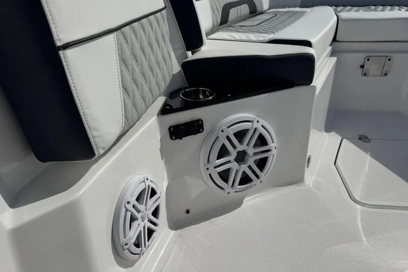 Slide: The Image of Interior of 2025 Blackfin 252 CC boat with speakers and cushioned seating. - 28