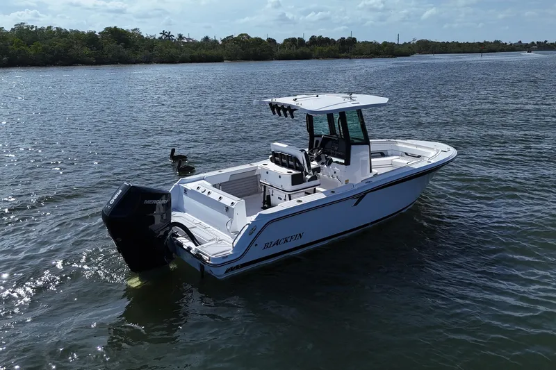 Slide: The Image of 2025 Blackfin 252 CC boat on calm water, featuring a sleek design and powerful engine. - 3