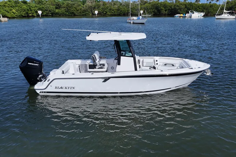 Slide: The Image of 2025 Blackfin 252 CC boat on calm water with Mercury engine. - 31