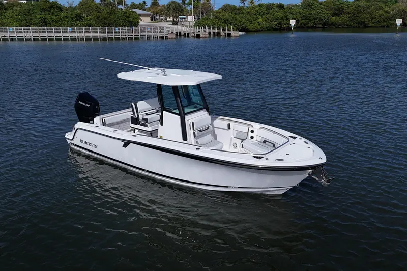 Slide: The Image of 2025 Blackfin 252 CC boat on calm water, showcasing sleek design and modern features. - 32