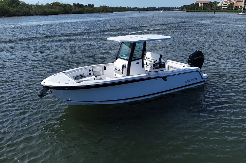 Slide: The Image of 2025 Blackfin 252 CC boat on calm water, showcasing sleek design and modern features. - 33