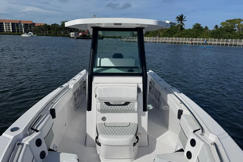 Slide: The Image of 2025 Blackfin 252 CC boat on water, showcasing sleek design and spacious deck. - 36