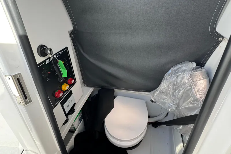 Slide: The Image of 2025 Blackfin 252 CC boat interior with control panel and compact toilet. - 37