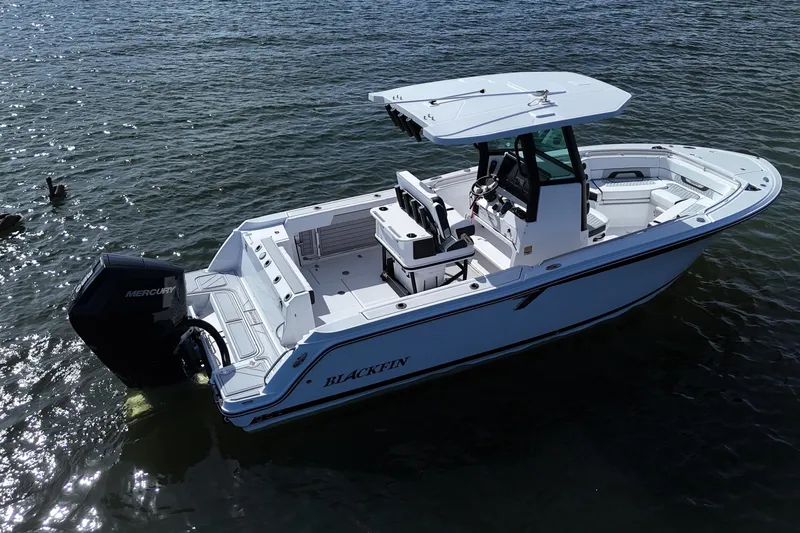 Slide: The Image of 2025 Blackfin 252 CC boat on water, featuring sleek design and powerful Mercury engine. - 4
