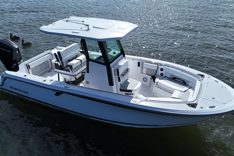 Slide: The Image of 2025 Blackfin 252 CC boat on water, featuring sleek design and spacious seating. - 5