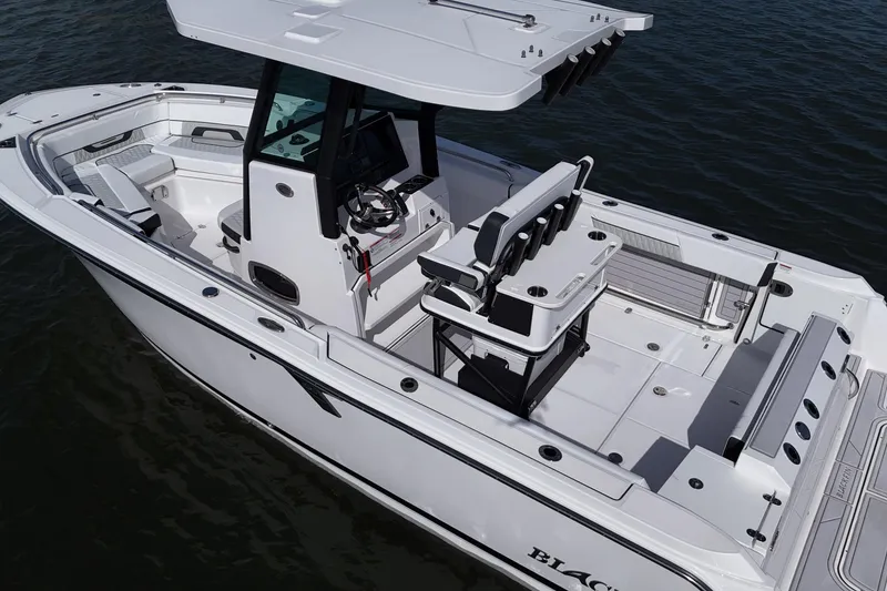 Slide: The Image of 2025 Blackfin 252 CC boat on water, showcasing spacious deck and modern design. - 7