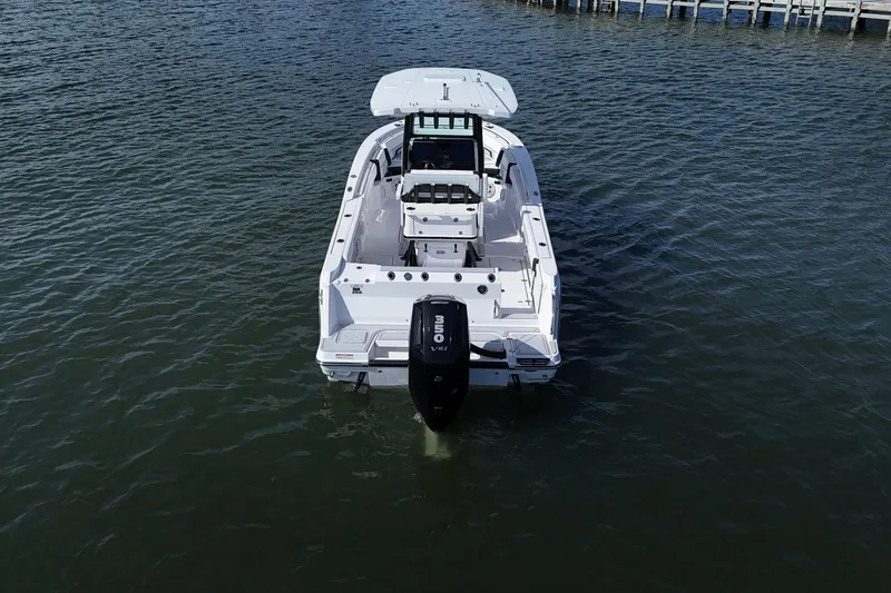 Slide: The Image of 2025 Blackfin 252 CC boat on water, rear view with outboard motor. - 8