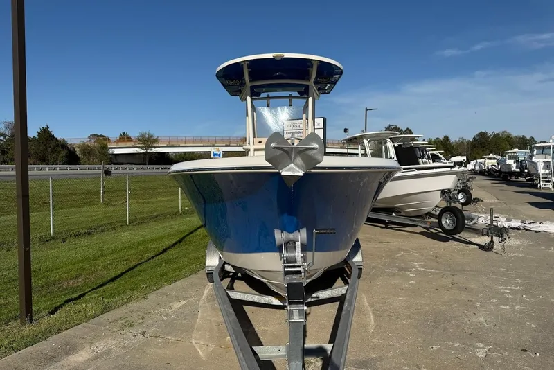 Slide: The Image of 2019 Sea Chaser 24 HFC boat on trailer, parked outdoors under clear blue sky. - 10