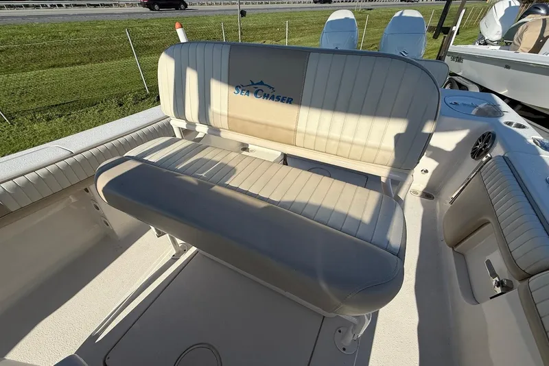 Slide: The Image of 2019 Sea Chaser 24 HFC boat interior with cushioned seating and logo. - 18