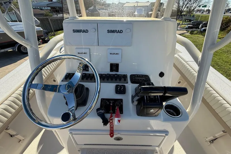 Slide: The Image of 2019 Sea Chaser 24 HFC boat console with steering wheel and controls. - 19