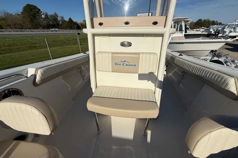Slide: The Image of 2019 Sea Chaser 24 HFC boat interior with beige seating and console. - 23