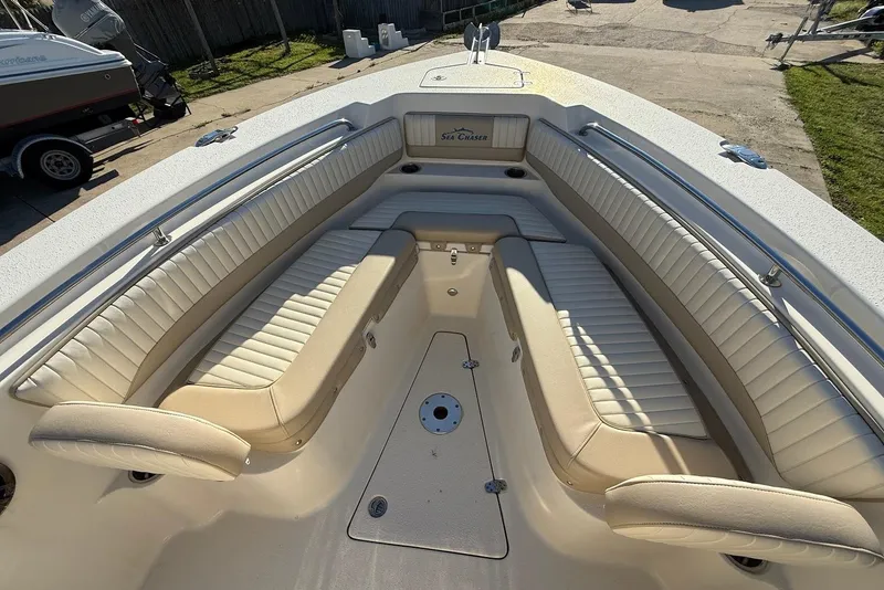 Slide: The Image of 2019 Sea Chaser 24 HFC boat interior with cushioned seating and spacious deck. - 25