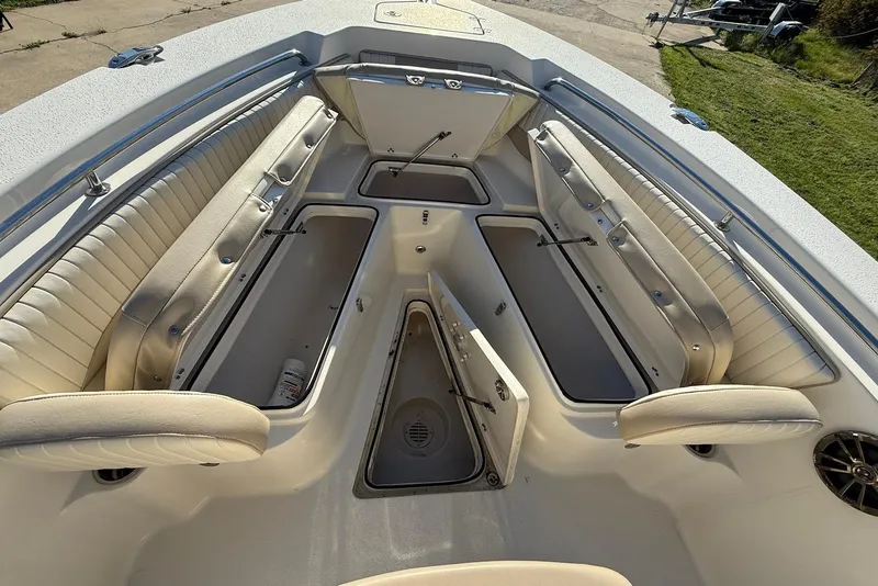 Slide: The Image of 2019 Sea Chaser 24 HFC boat interior with open storage compartments and cushioned seating. - 26