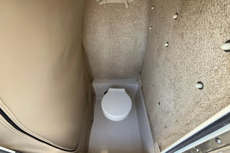 Slide: The Image of 2019 Sea Chaser 24 HFC boat interior with compact marine toilet. - 30