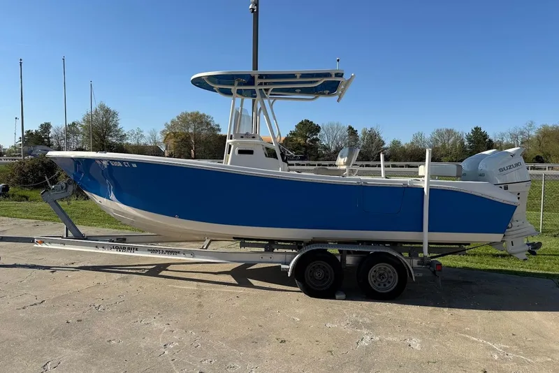 The Image of 2019 Sea Chaser 24 HFC boat on trailer, blue hull, Suzuki outboard motor. - 5
