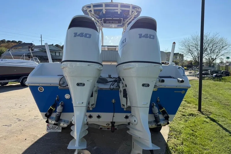 Slide: The Image of 2019 Sea Chaser 24 HFC boat with dual 140 horsepower outboard engines, parked outdoors. - 7