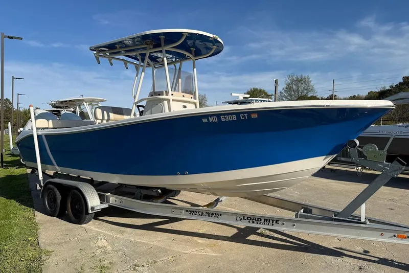 Slide: The Image of 2019 Sea Chaser 24 HFC boat on trailer, blue hull, parked outdoors. - 9