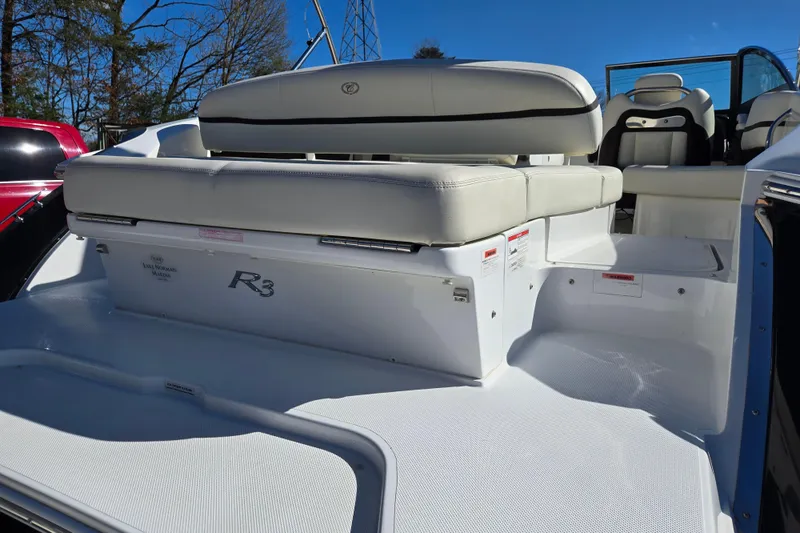 Slide: The Image of 2016 Cobalt R3 boat with white seating and sleek design, parked outdoors. - 13