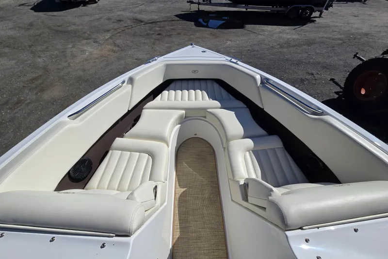 Slide: The Image of 2016 Cobalt R3 boat interior with white cushioned seating and sleek design. - 16