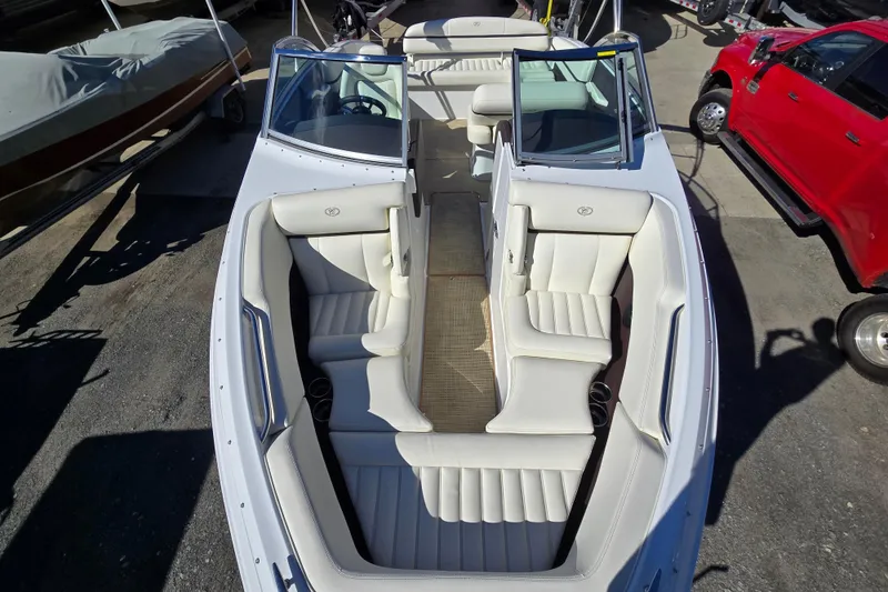 Slide: The Image of 2016 Cobalt R3 boat with white leather seating, docked near a red vehicle. - 17
