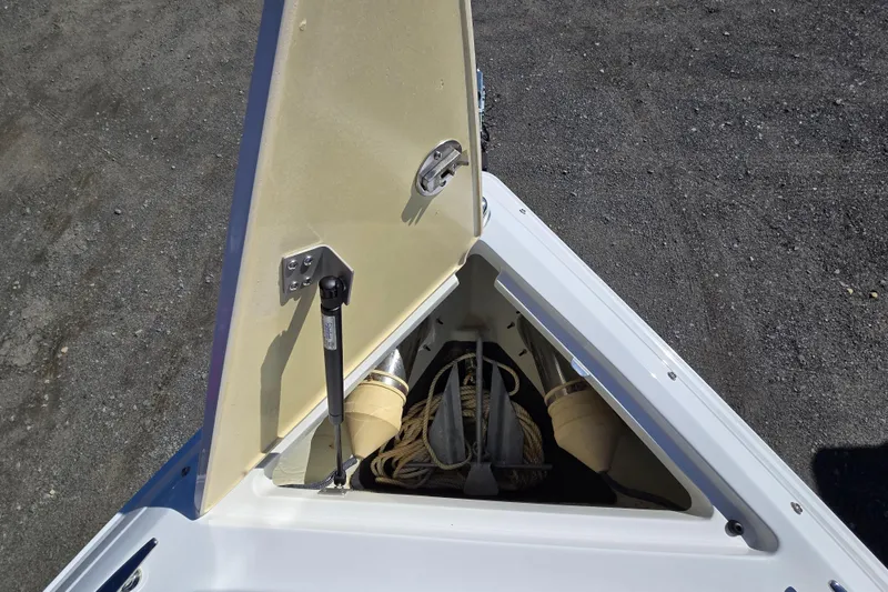 Slide: The Image of Open storage compartment on 2016 Cobalt R3 boat, containing ropes and anchor. - 21