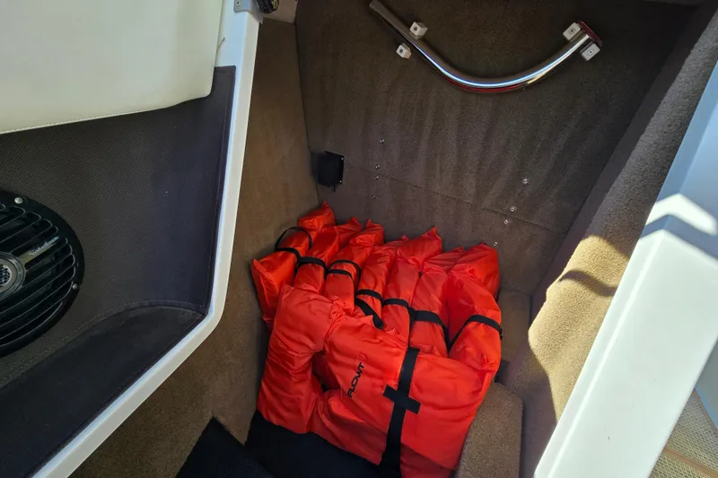 Slide: The Image of Storage compartment in 2016 Cobalt R3 boat with orange life jackets. - 24