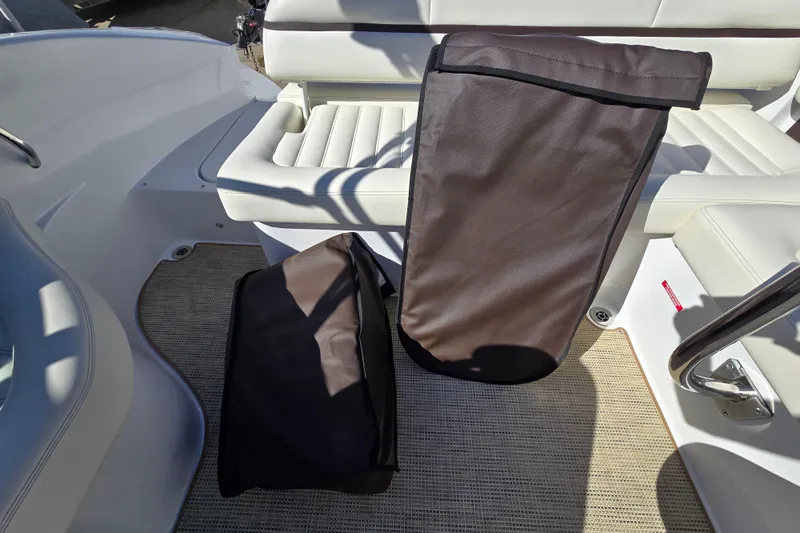 Slide: The Image of 2016 Cobalt R3 boat interior with protective covers on white seating. - 25