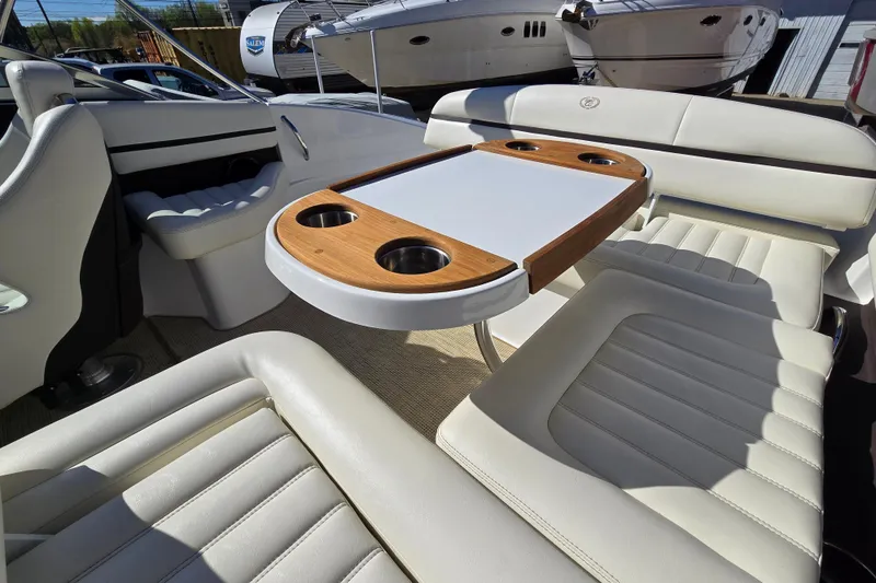 Slide: The Image of Luxurious interior of a 2016 Cobalt R3 boat with white leather seating and wooden table. - 26