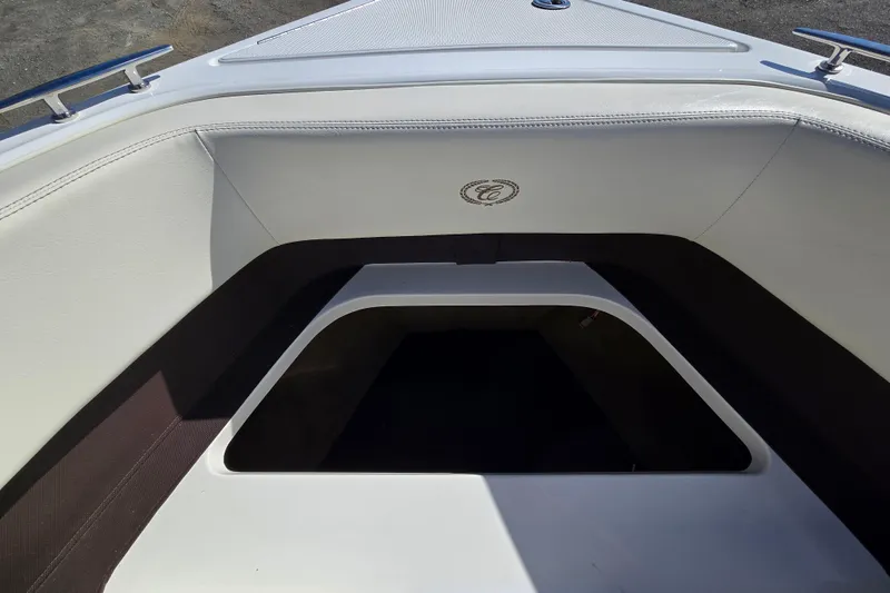 Slide: The Image of Interior view of a 2016 Cobalt R3 boat, featuring white seating and storage area. - 30