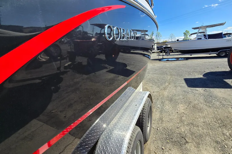 Slide: The Image of 2016 Cobalt R3 boat with red stripe on trailer in outdoor setting. - 4