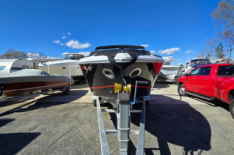 Slide: The Image of 2016 Cobalt R3 boat on trailer, surrounded by other boats and a red truck under a clear blue sky. - 5