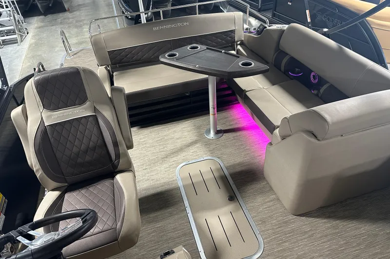 Slide: The Image of 2023 Bennington 25LTSB boat interior with luxurious seating and ambient lighting. - 5