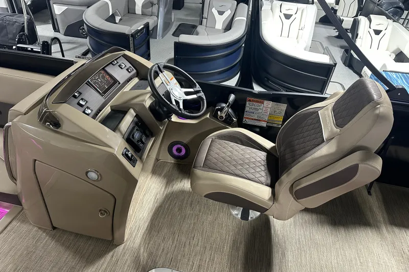 Slide: The Image of 2023 Bennington 25LTSB boat interior with luxurious captain's chair and modern dashboard controls. - 6