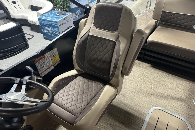 Slide: The Image of 2023 Bennington 25LTSB boat interior with luxurious seating and steering wheel. - 7
