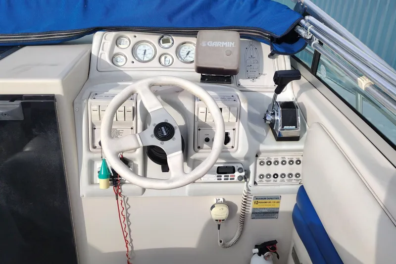 Slide: The Image of Cockpit of a 1996 Crownline 250 CR boat with steering wheel and control panel. - 10