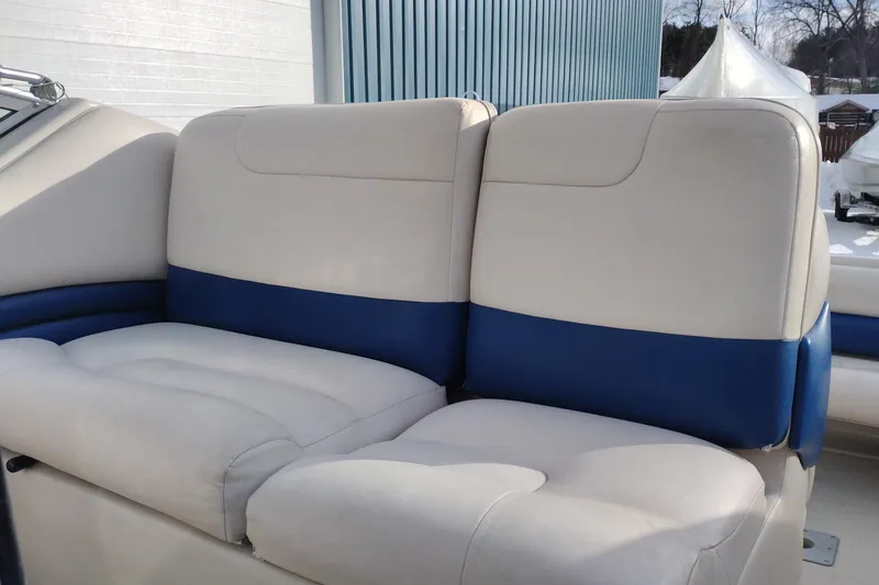 Slide: The Image of Crownline 250 CR 1996 boat interior with beige and blue cushioned seating. - 11