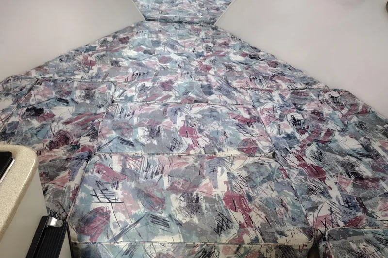 Slide: The Image of Interior of a 1996 Crownline 250 CR boat with abstract-patterned upholstery. - 12