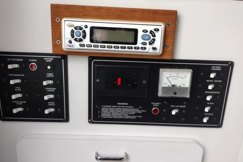 Slide: The Image of Control panel of a 1996 Crownline 250 CR boat with switches and gauges. - 16