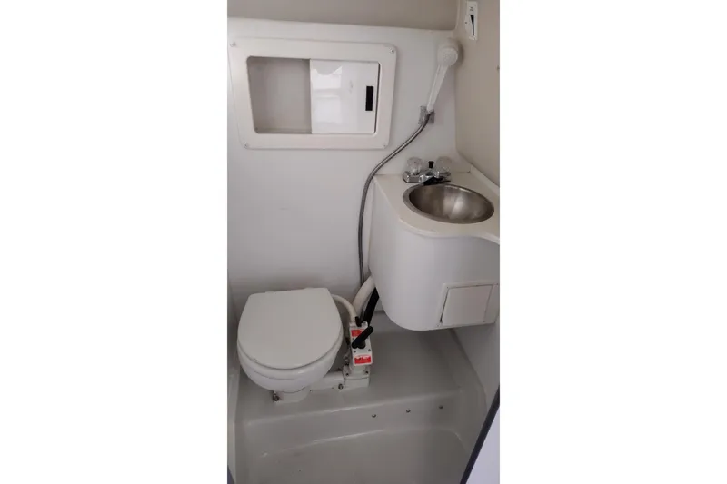 Slide: The Image of 1996 Crownline 250 CR boat bathroom with toilet and sink. - 17