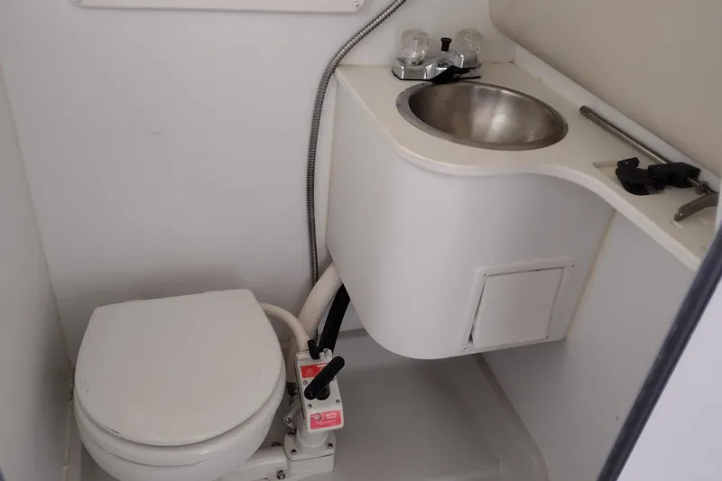 Slide: The Image of 1996 Crownline 250 CR boat bathroom with toilet and sink. - 18