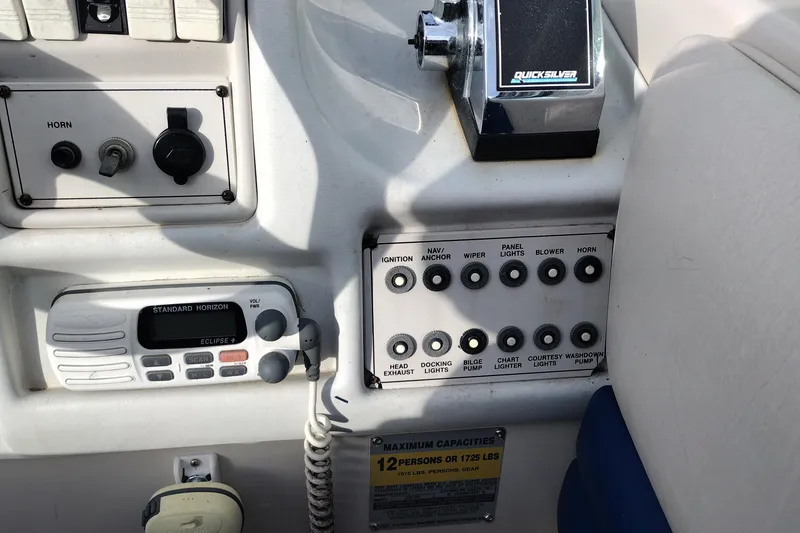 Slide: The Image of Control panel of a 1996 Crownline 250 CR boat with various switches and radio. - 21