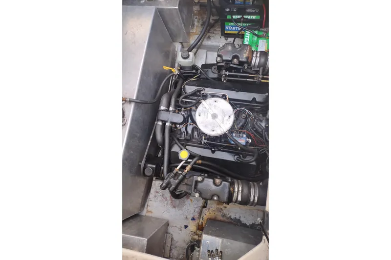 Slide: The Image of Engine compartment of a 1996 Crownline 250 CR boat, showing detailed mechanical components. - 24